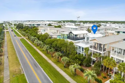 an aerial view of a street with houses and palm trees at Walkin on Sunshine by 30A Escapes in Rosemary Beach
