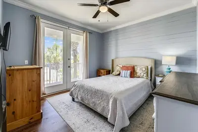 a bedroom with a bed and a ceiling fan at Emerald Escape by 30A Escapes in Rosemary Beach
