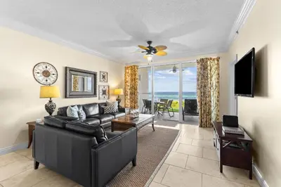 a living room with a couch and a television at HP 15E Gulf Front Condo by 30A Escapes in Rosemary Beach