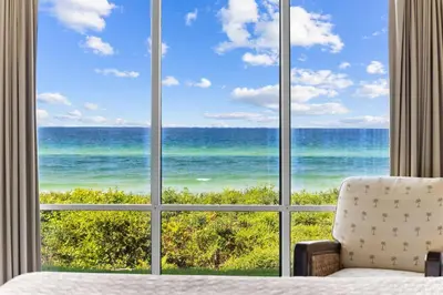 a room with a view of the ocean through a window at HP 15E Gulf Front Condo by 30A Escapes in Rosemary Beach