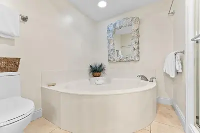 a white bathroom with a sink and a toilet at HP 15E Gulf Front Condo by 30A Escapes in Rosemary Beach