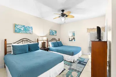 a bedroom with two beds and a ceiling fan at HP 15E Gulf Front Condo by 30A Escapes in Rosemary Beach