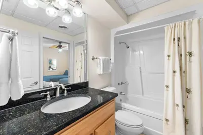 a bathroom with a sink and a toilet and a shower at HP 15E Gulf Front Condo by 30A Escapes in Rosemary Beach