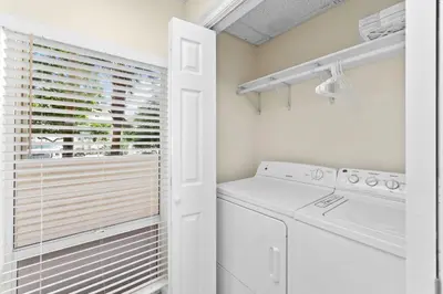a laundry room with a washer and dryer at HP 15E Gulf Front Condo by 30A Escapes in Rosemary Beach