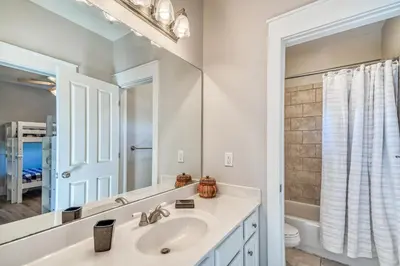 a bathroom with a sink and a mirror at Happy Place by 30A Escapes in Rosemary Beach