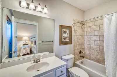 a bathroom with a sink and a toilet and a mirror at Happy Place by 30A Escapes in Rosemary Beach