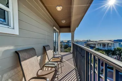 two chairs on a balcony with a view of the ocean at Happy Place by 30A Escapes in Rosemary Beach