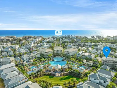 an aerial view of a resort with a pool and the ocean at Happy Place by 30A Escapes in Rosemary Beach