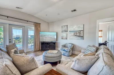 a living room with two couches and a tv at Happy Place by 30A Escapes in Rosemary Beach