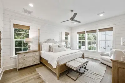 a bedroom with a bed and a couch and windows at Tidey Whitey by 30A Escapes in Seacrest