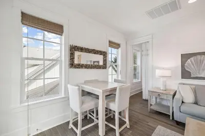 a dining room with a table and chairs at Tidey Whitey by 30A Escapes in Seacrest