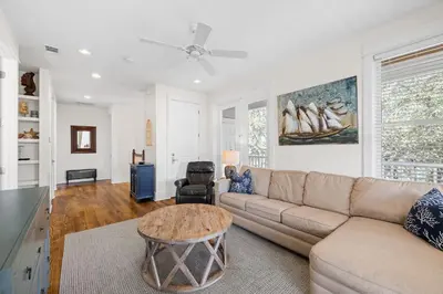 a living room with a couch and a table at Sand Pointe by 30A Escapes in Inlet Beach