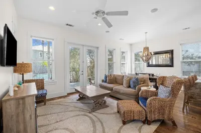 a living room with a couch and chairs and a table at Sand Pointe by 30A Escapes in Inlet Beach