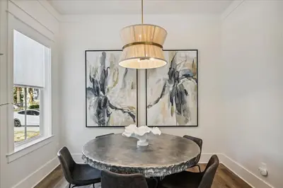 a dining room with a table and chairs at Sea Ya Soon by 30A Escapes in Rosemary Beach
