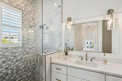 a bathroom with a sink and a shower with a mirror at Sea Ya Soon by 30A Escapes in Rosemary Beach