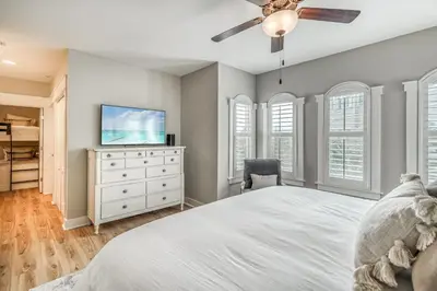 a bedroom with a bed and a flat screen tv at Poolside Paradise by 30A Escapes in Rosemary Beach