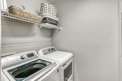 a laundry room with a washer and dryer at Poolside Paradise by 30A Escapes in Rosemary Beach