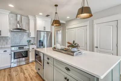 a kitchen with white cabinets and a white counter top at Poolside Paradise by 30A Escapes in Rosemary Beach