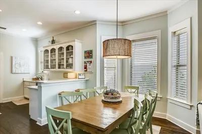 a kitchen and dining room with a wooden table and chairs at Endless Summer Escape by 30A Escapes in Rosemary Beach