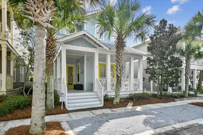 a white house with palm trees in front of it at Endless Summer Escape by 30A Escapes in Rosemary Beach