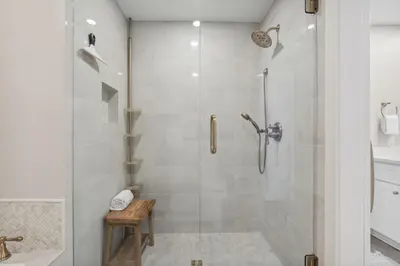 a bathroom with a shower with a glass door at HP 45W What the Heck by 30A Escapes in Rosemary Beach