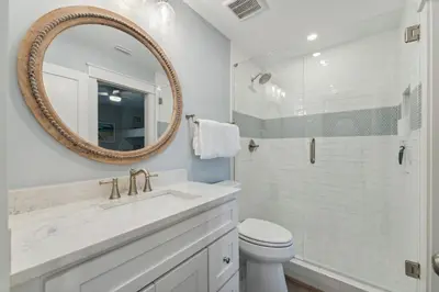 a bathroom with a sink and a toilet and a mirror at HP 45W What the Heck by 30A Escapes in Rosemary Beach