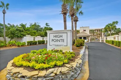 a sign for a high route with flowers and palm trees at HP 45W What the Heck by 30A Escapes in Rosemary Beach