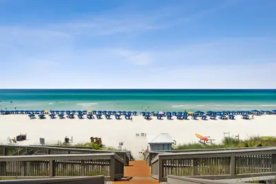 a view of a beach with chairs and the ocean at HP 45W What the Heck by 30A Escapes in Rosemary Beach