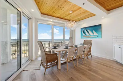 a dining room with a table and chairs at HP 21W Gulf Front Condo by 30A Escapes in Rosemary Beach