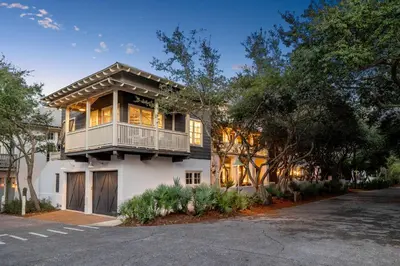 a house with a balcony on the side of it at Stairway to Heaven Carriage by 30A Escapes in Rosemary Beach