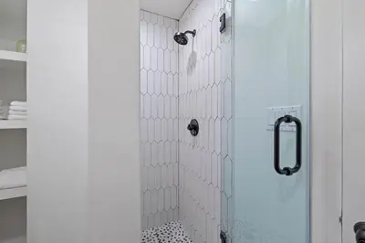 a shower with a glass door in a bathroom at Stairway to Heaven Carriage by 30A Escapes in Rosemary Beach