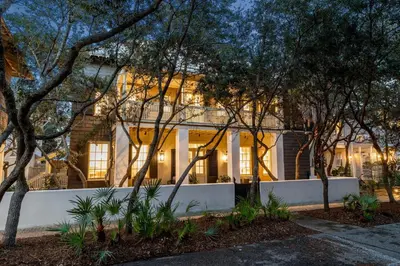 a white house with trees in front of it at Stairway to Heaven Carriage by 30A Escapes in Rosemary Beach