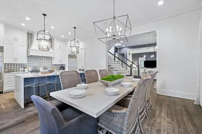a kitchen and dining room with a table and chairs at Stairway to Heaven Cottage by 30A Escapes in Rosemary Beach