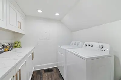 a white laundry room with a washer and dryer at Stairway to Heaven Cottage by 30A Escapes in Rosemary Beach