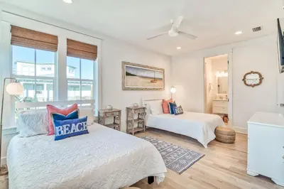 a bedroom with two beds and a window at 100 Lifeguard Loop East by 30A Escapes in Rosemary Beach