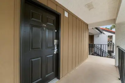 a black door on the side of a building at Edgewater Golf Villas #1714 by InJoy Vacations in Panama City Beach