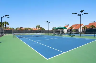 a tennis court with two tennis courts at Edgewater Golf Villas #1714 by InJoy Vacations in Panama City Beach