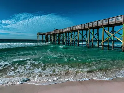 a pier on the beach near the ocean at Edgewater Golf Villas #1714 by InJoy Vacations in Panama City Beach