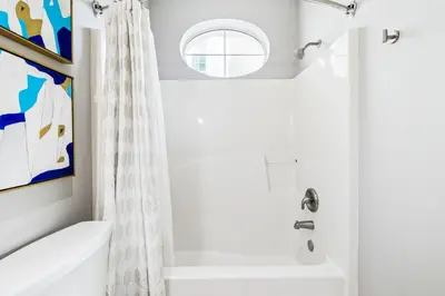 a bathroom with a white tub and a shower at Sunset Beach 102C by 30A Escapes in Rosemary Beach