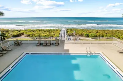 a swimming pool with a view of the ocean at Sunset Beach 102C by 30A Escapes in Rosemary Beach