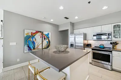 a kitchen with a table and chairs in a room at Sunset Beach 102C by 30A Escapes in Rosemary Beach