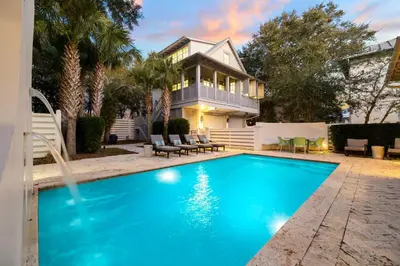 a house with a swimming pool in front of a house at 103 E Kingston by 30A Escapes in Rosemary Beach