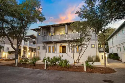 a large white house with trees in front of it at 103 E Kingston by 30A Escapes in Rosemary Beach