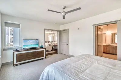 a bedroom with a bed and a flat screen tv at The Pointe Unit 321 by 30A Escapes in Rosemary Beach