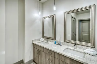 a bathroom with two sinks and two mirrors at The Pointe Unit 321 by 30A Escapes in Rosemary Beach