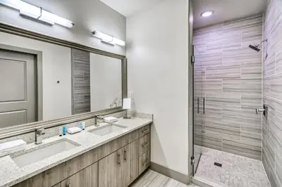 a bathroom with two sinks and a large mirror at The Pointe Unit 321 by 30A Escapes in Rosemary Beach
