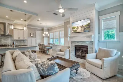 a living room with a couch and a fireplace at Sanity By the Sea by 30A Escapes in Inlet Beach