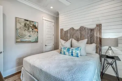 a bedroom with a bed with a bicycle painting on the wall at Sanity By the Sea by 30A Escapes in Inlet Beach