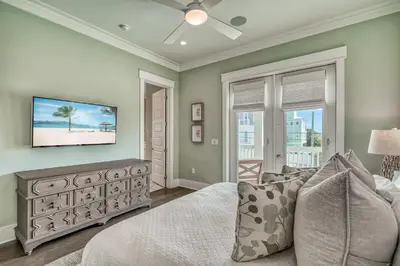 a bedroom with a bed and a television on the wall at Sanity By the Sea by 30A Escapes in Inlet Beach