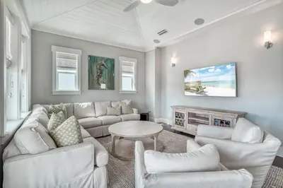 a living room with white furniture and a fireplace at Sanity By the Sea by 30A Escapes in Inlet Beach